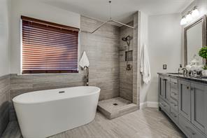 Featuring a sleek walk-in shower, a serene freestanding tub, and double sinks with contemporary fixtures, this bathroom is designed for both style and relaxation. The convenient headknocker cabinet adds extra storage, ensuring a clutter-free oasis where you can unwind and recharge. Completing the space is a comfort-height toilet, offering ease and comfort, making this bathroom a true retreat in the comfort of your own home.