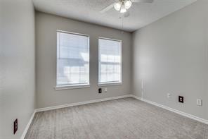 The secondary bedroom is bright and welcoming, with natural light streaming through the large windows. Recently updated with plush carpet and a new pad, this room offers both comfort and style, creating a cozy retreat for relaxation or a peaceful night’s rest