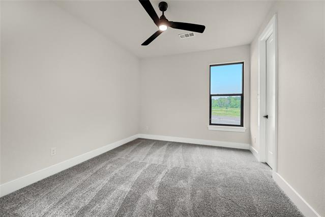 Bathroom featuring vanity, quartz counters, framed mirror, tile floors, frameless glass shower 
