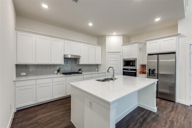 Carpeted spare room featuring vaulted ceiling