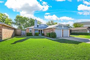View of front of property with a front yard and a garage