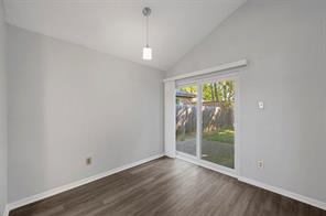Primary Bedroom featuring ceiling fan, a textured ceiling, lofted ceiling, and wood-style floors