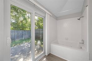 3rd bedroom with a textured ceiling, dark colored carpet, and a closet