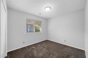 Full bathroom with wood-type flooring, a textured ceiling, shower / washtub combination, vanity, and toilet