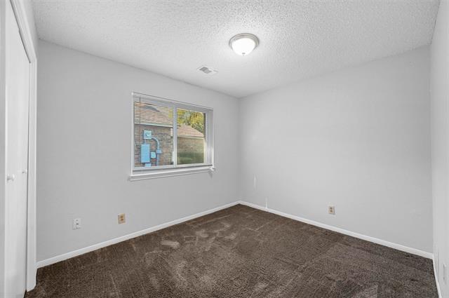 Full bathroom with wood-type flooring, a textured ceiling, shower / washtub combination, vanity, and toilet