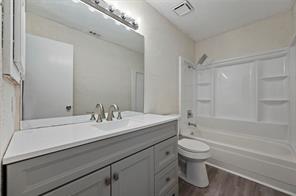 2nd bedroom featuring dark carpet, a textured ceiling and updated window