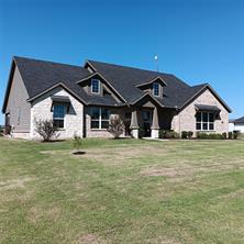 View of front of house with a garage and a shed (workshop) in backyard