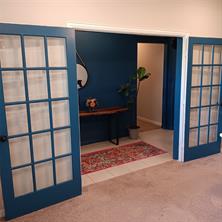 Living room and dining areas featuring ceiling fan and dark hardwood flooring