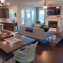 Living room with ceiling fan and dark hardwood flooring